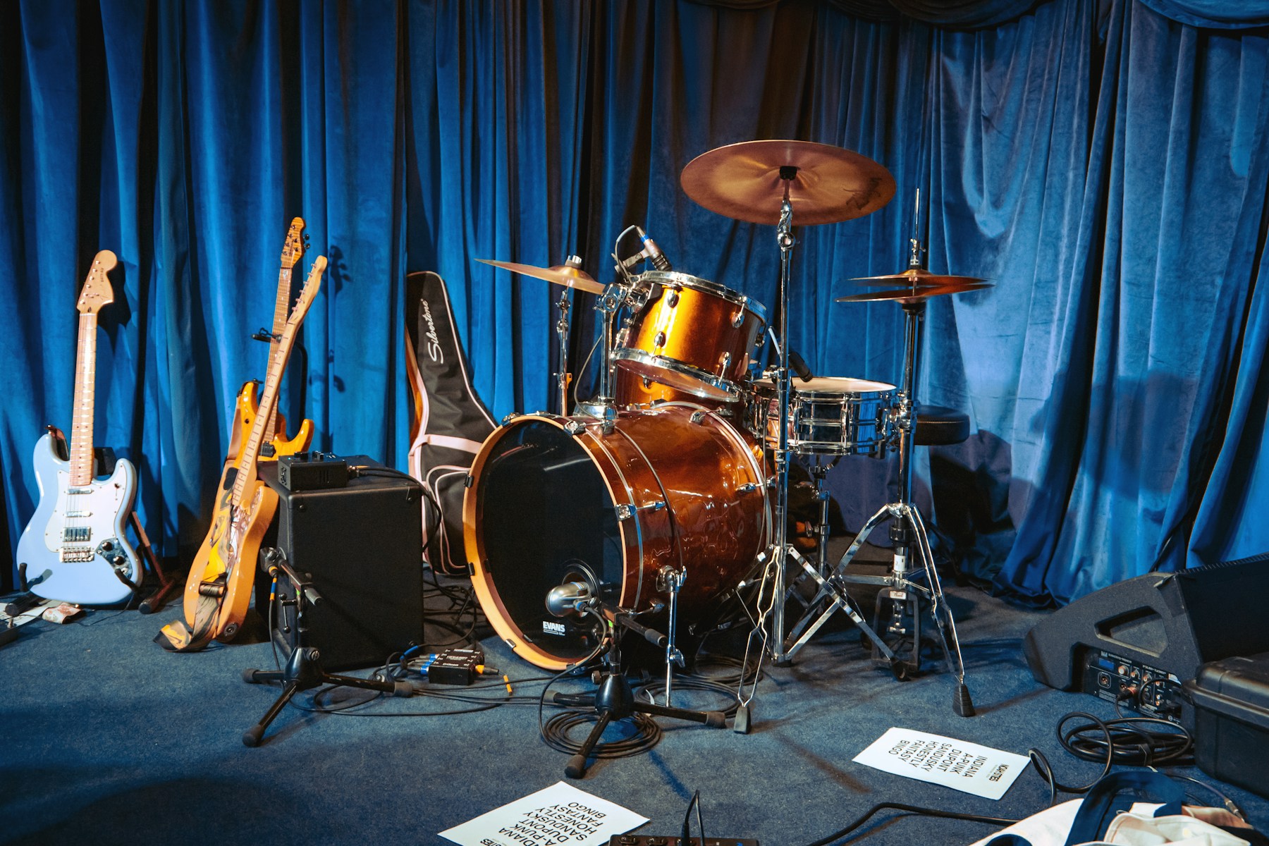 Drums, guitars and amplifiers ready on a small venue stage